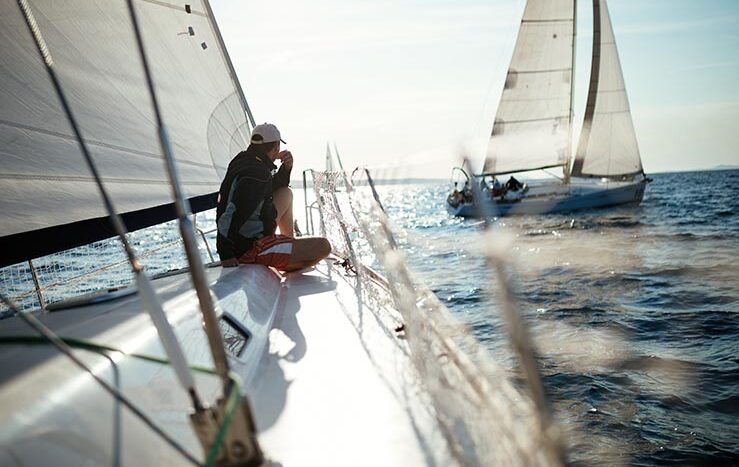 Young handsome man relaxing on his sport sailboat